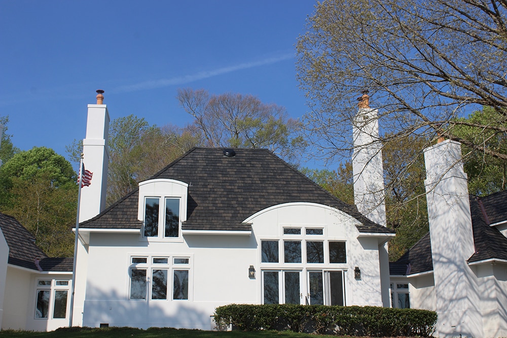 Thanks to their long-lasting synthetic shake roof, these homeowners now enjoy the look of authentic shake without natural humidity shortening their roof's lifespan.