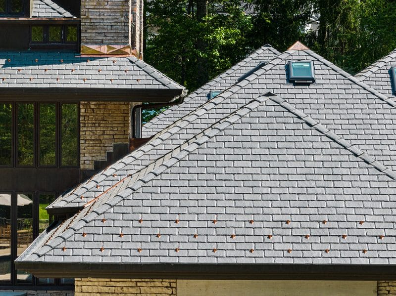 According to the homeowner, authentic composite slate complements this home's unique exterior even better than the original special-order roof. 