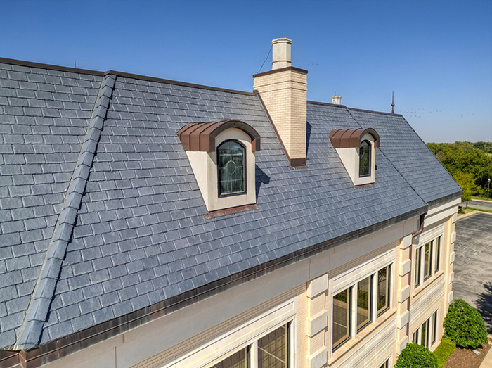 This composite slate mansard roof will protect the building for decades to come while perfectly completing its architectural aesthetic. 